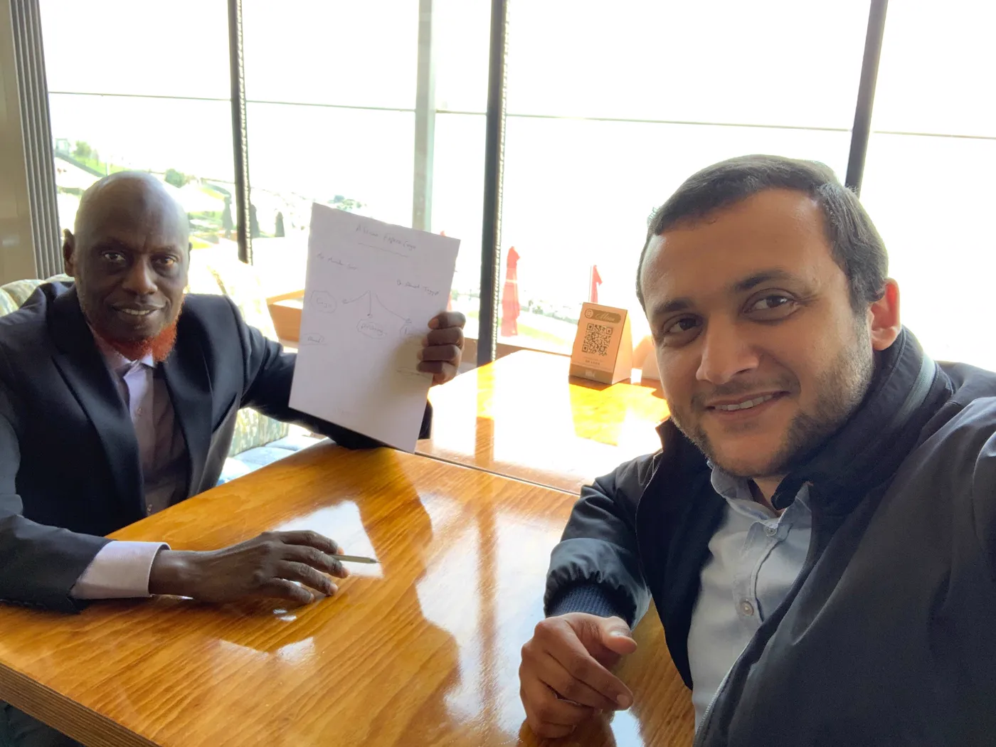 Ahmet Tayyip and El Hadj Mamadou Sarr drafting the cargo plan over a table in Istanbul